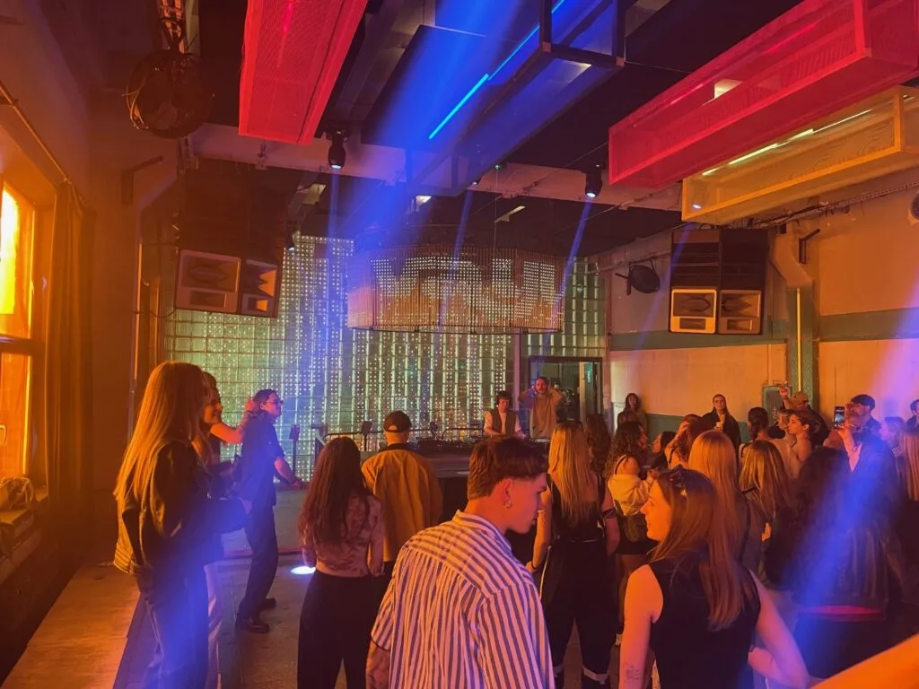 The vast industrial interior of Gallery 1986 in Vilnius, a former radio factory turned electronic music venue and cultural space with dramatic lighting.