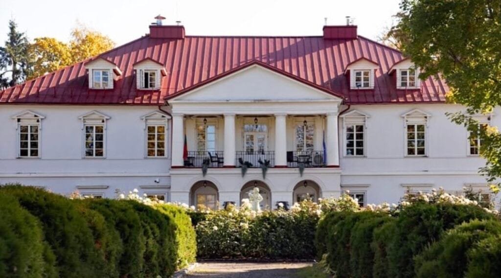 The neo-classical facade of Bistrampolis Manor, a hub for culture and music.