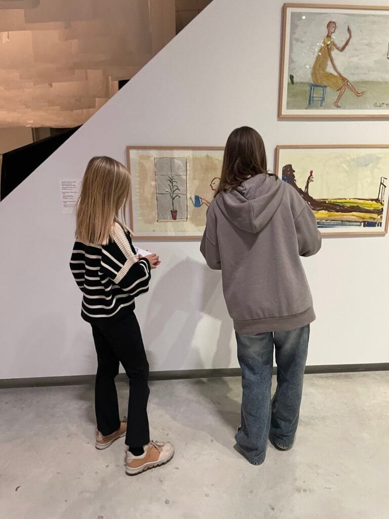 The modern white exterior architecture of MO Museum in Vilnius designed by Daniel Libeskind, featuring the outdoor terrace and sculpture garden.