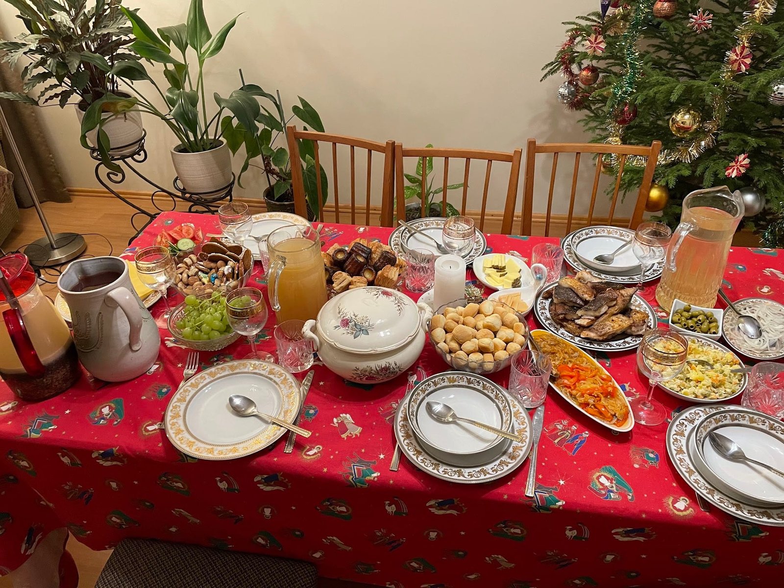 Traditional Lithuanian Kūčios (Christmas Eve) feast set on a red tablecloth.