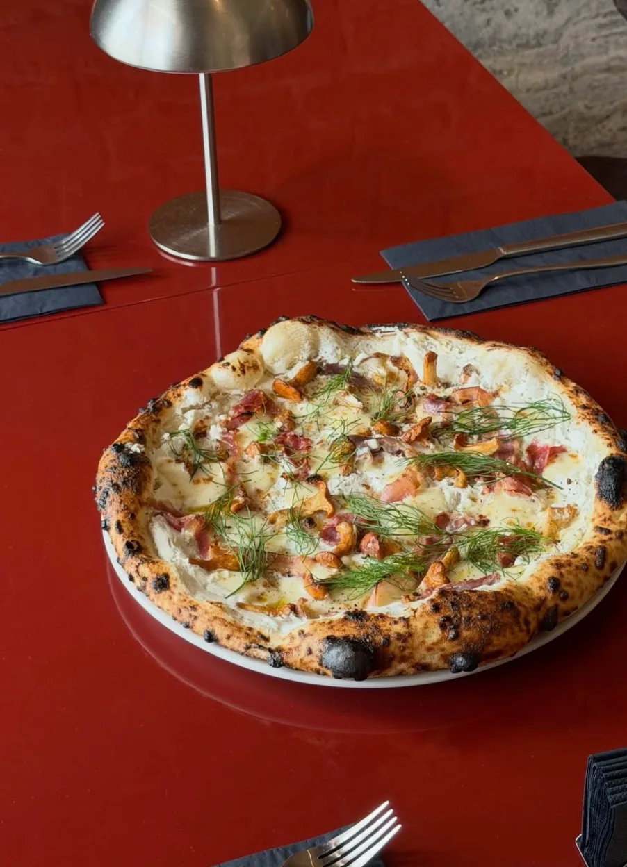 Gourmet Neapolitan pizza served on a table at Neighbourhood Pizza & Wine Bar.