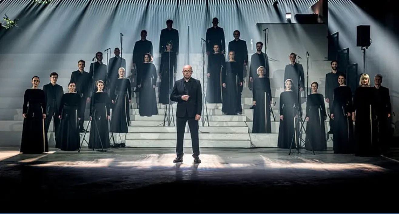 Choir and conductor performing under stage spotlights at Pazaislis Music Festival