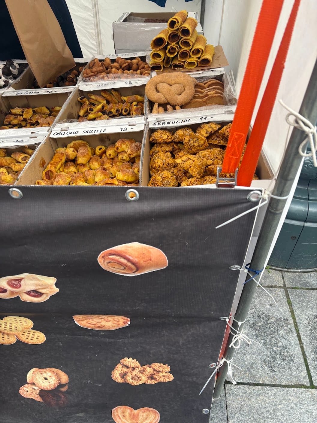 Market stall display filled with traditional pastries and cookies at Kaziukas Fair.