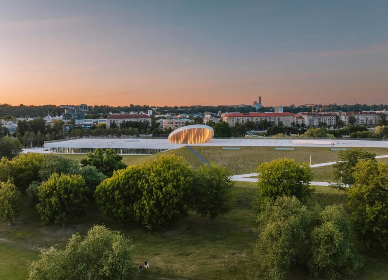Aerial view of the futuristic Science Island building on Nemunas Island in Kaunas at sunset.