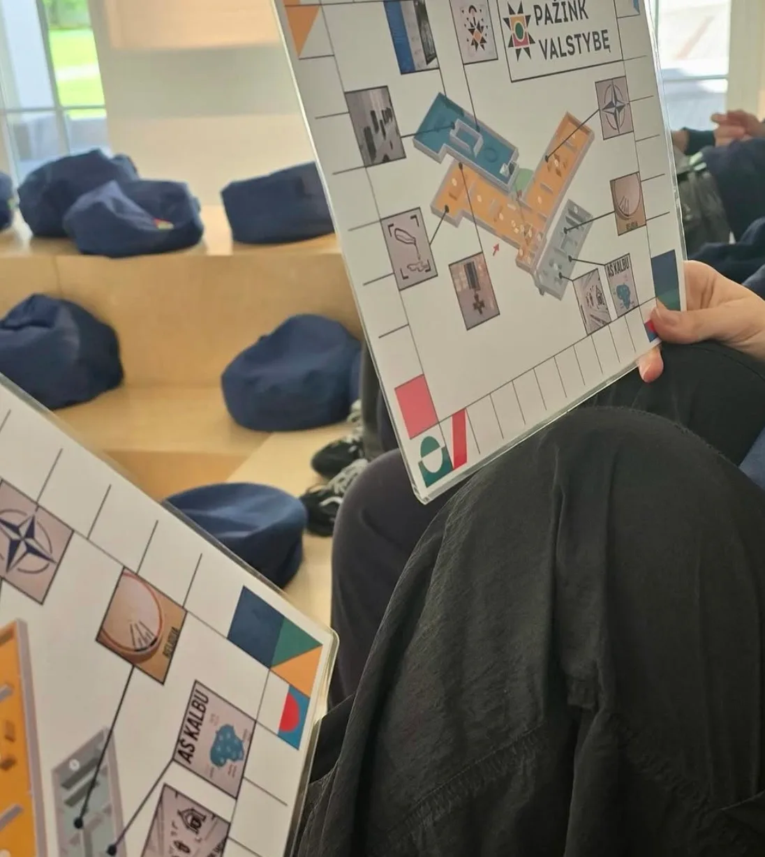 Visitors holding interactive scheme cards at the State Knowledge Center.