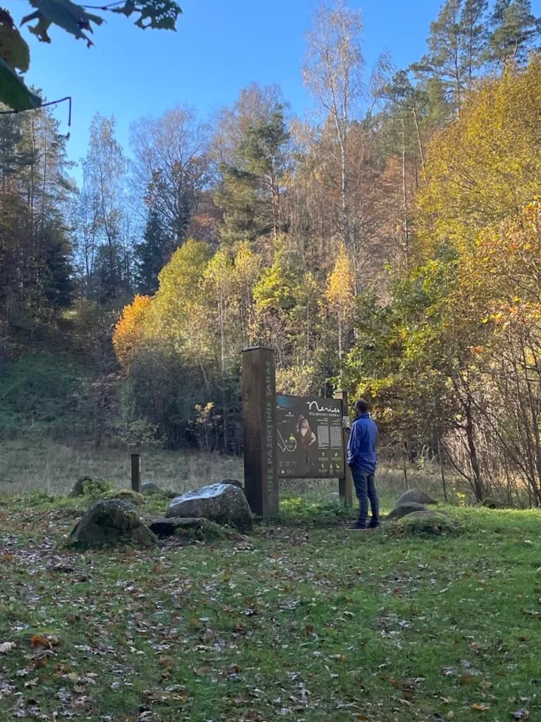 Man standing at an information board along the Neris Regional Park educational trail