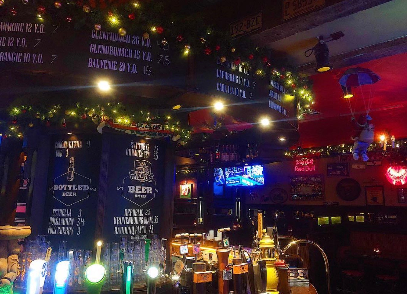Cozy interior of Republic No.1 bar with draft beer menu taps and holiday lights.