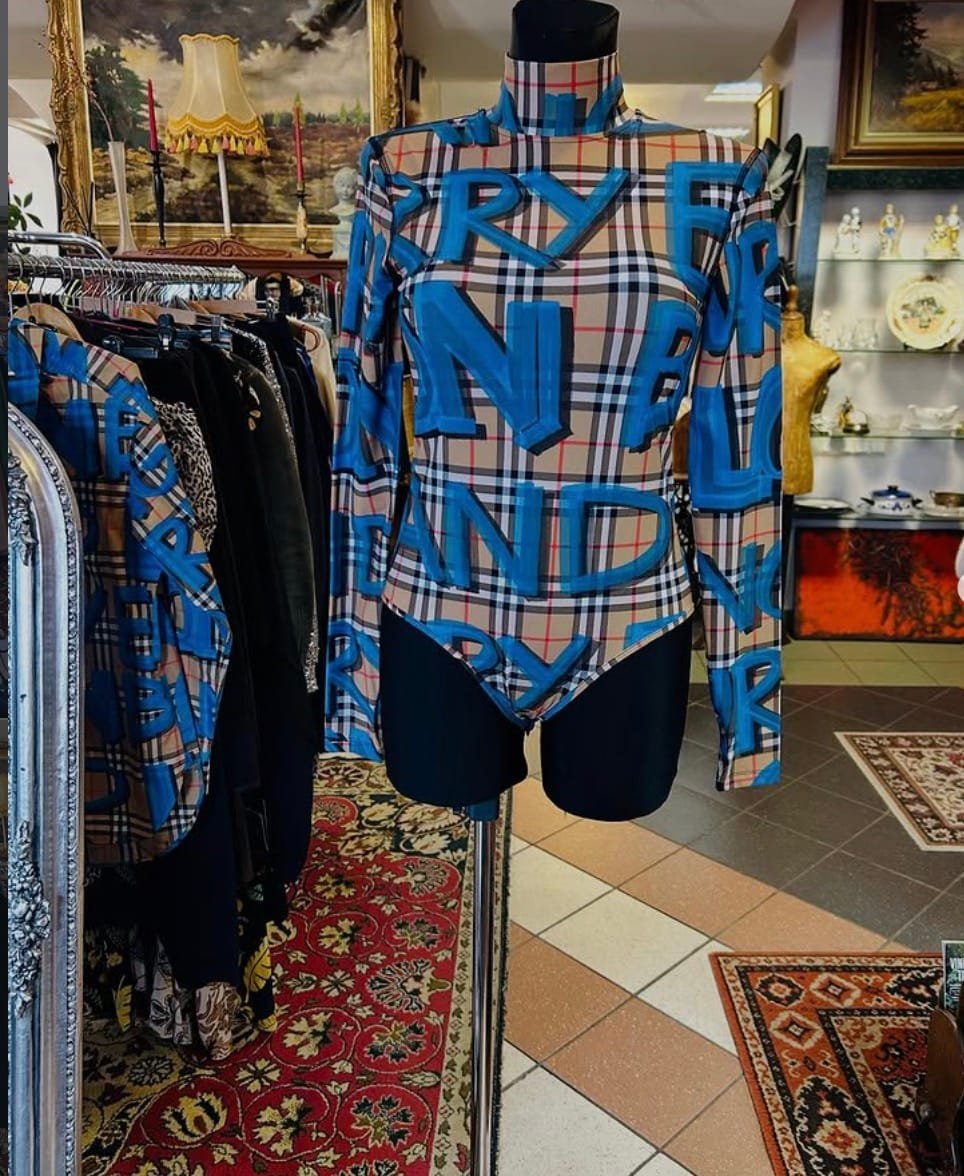 Stylish patterned bodysuit displayed on a mannequin in a vintage shop.