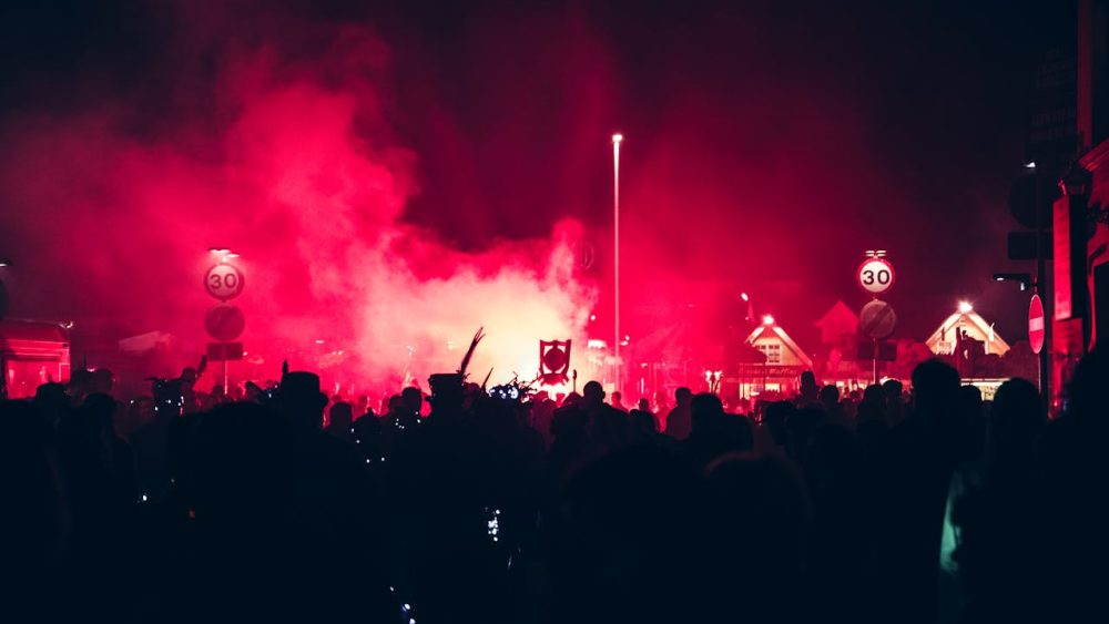 Crowds gather under red lights at a vibrant night festival, showcasing the best Events in Vilnius with music, culture, and celebrations.