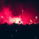 Crowds gather under red lights at a vibrant night festival, showcasing the best Events in Vilnius with music, culture, and celebrations.