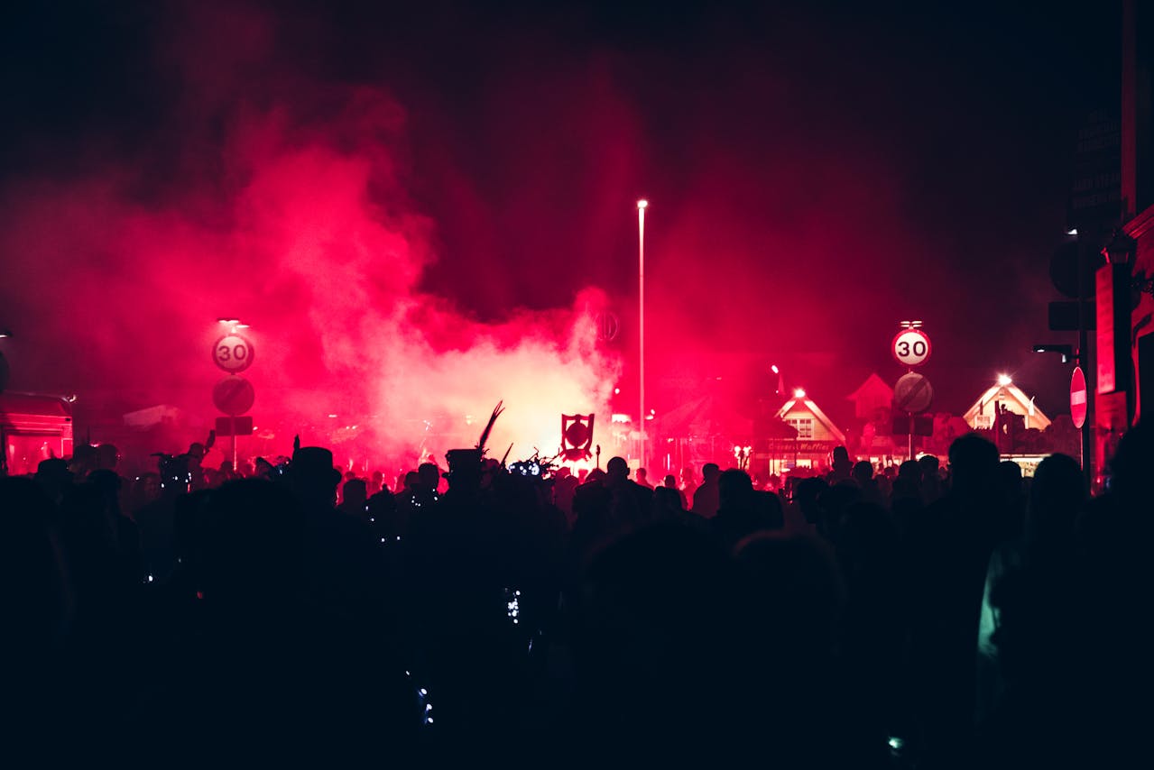 Crowds gather under red lights at a vibrant night festival, showcasing the best Events in Vilnius with music, culture, and celebrations.