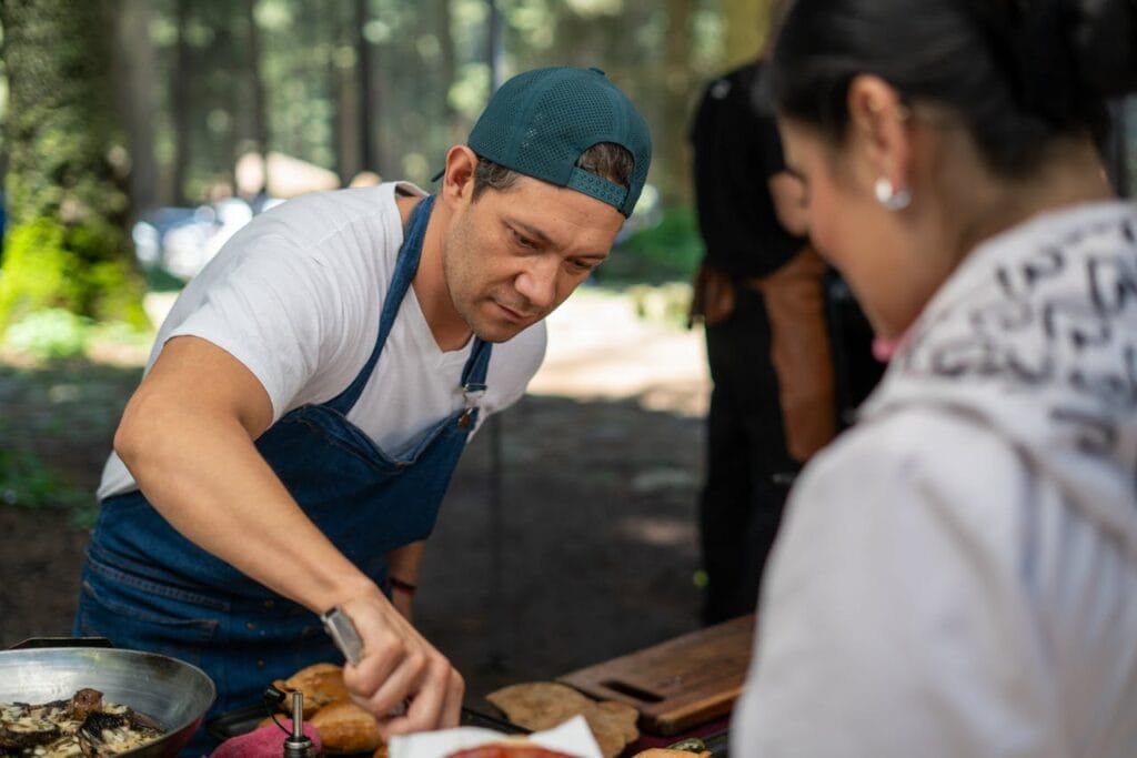 Chef serving food at an outdoor event during Food and Drink Festivals in Lithuania.