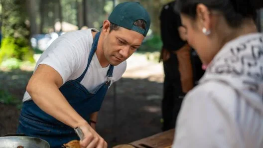 Chef serving food at an outdoor event during Food and Drink Festivals in Lithuania.