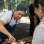 Chef serving food at an outdoor event during Food and Drink Festivals in Lithuania.