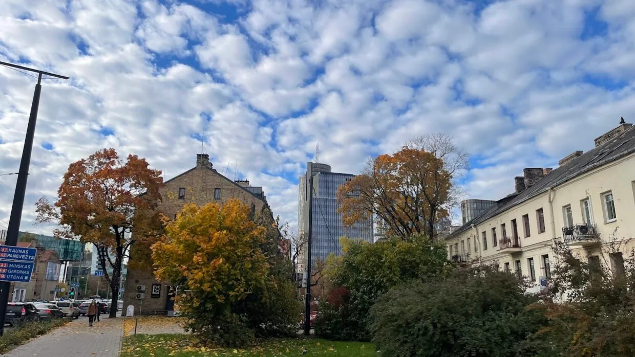 Vilnius skyline with modern offices and green spaces — one of the best cities in Lithuania for expats to work.