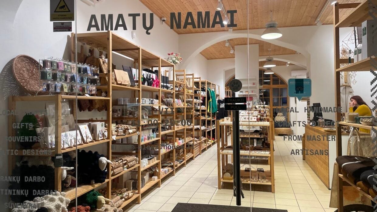 People shopping in Kaunas on Laisvės Alėja, surrounded by boutiques and café terraces in the Old Town.
