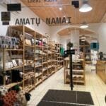 People shopping in Kaunas on Laisvės Alėja, surrounded by boutiques and café terraces in the Old Town.