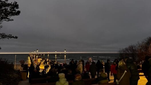 Palanga bridge stretching into the icy Baltic Sea during a quiet winter evening