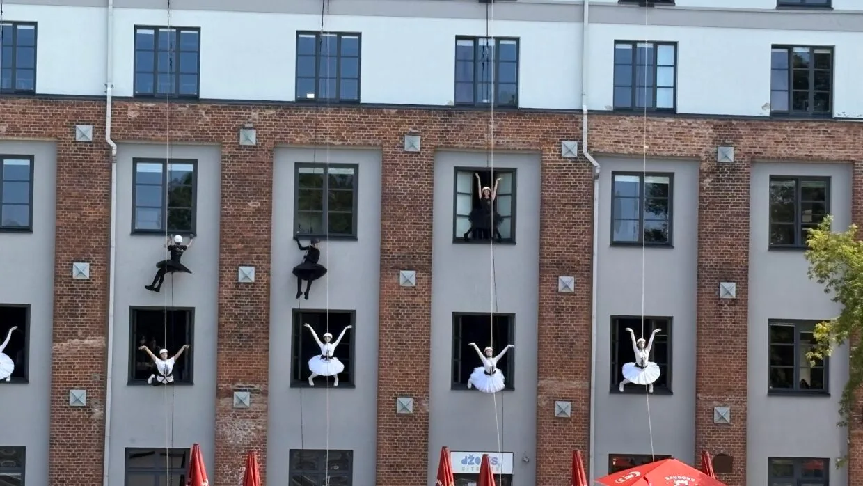 Kaunas cultural festivals - dancers performing a vertical dance show on a building facade