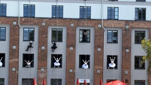 Kaunas cultural festivals - dancers performing a vertical dance show on a building facade