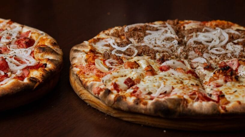 Two baked pizzas served on wooden boards for a guide on the best pizza in Kaunas.