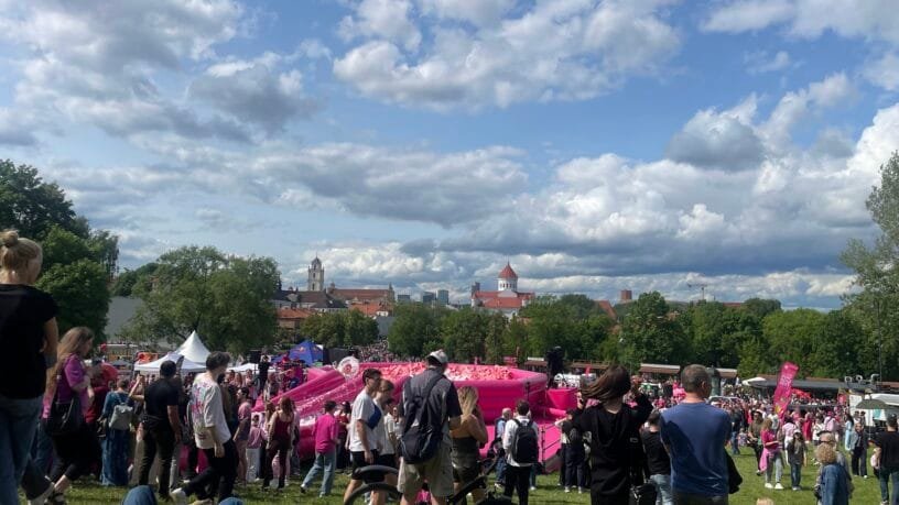 Crowd gathered outdoors, showcasing traditional festivals in Lithuania.
