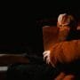 Person sitting in a cinema theater holding popcorn - Lithuanian movies in 2026.