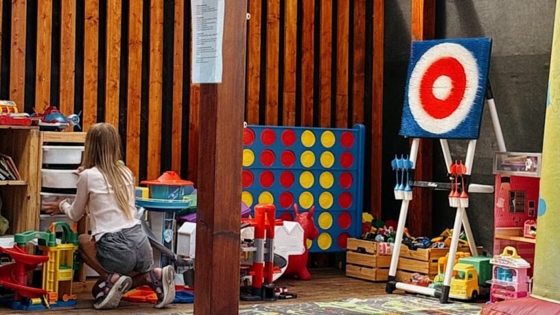 Girl playing in a designated kids' play area with toys and games - family friendly restaurants in Kaunas.