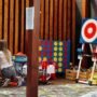 Girl playing in a designated kids' play area with toys and games - family friendly restaurants in Kaunas.