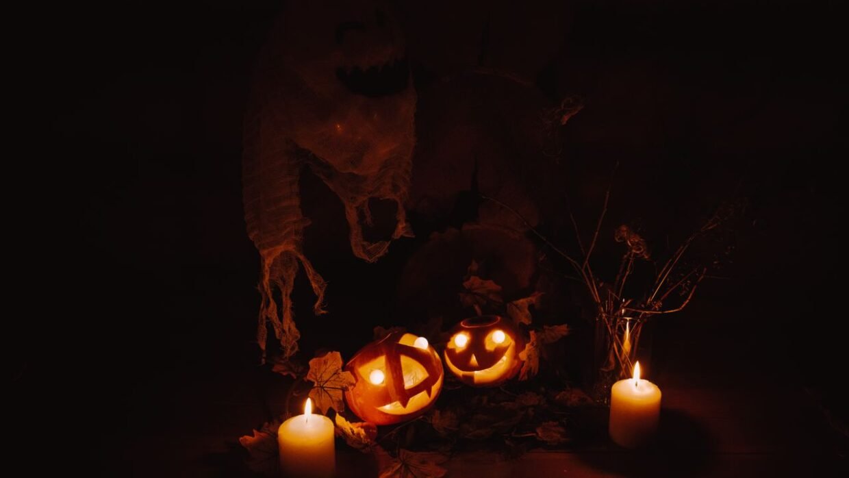 Carved glowing jack-o'-lantern pumpkins and candles illuminated in the dark - pumpkin events in Lithuania.